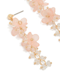 Detailed view of acrylic flower drop earrings with gold bead accents close up view - link has visual effect only