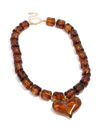 Crafted with brown square bead and heart necklace featuring statement in gold tones front view - link has visual effect only