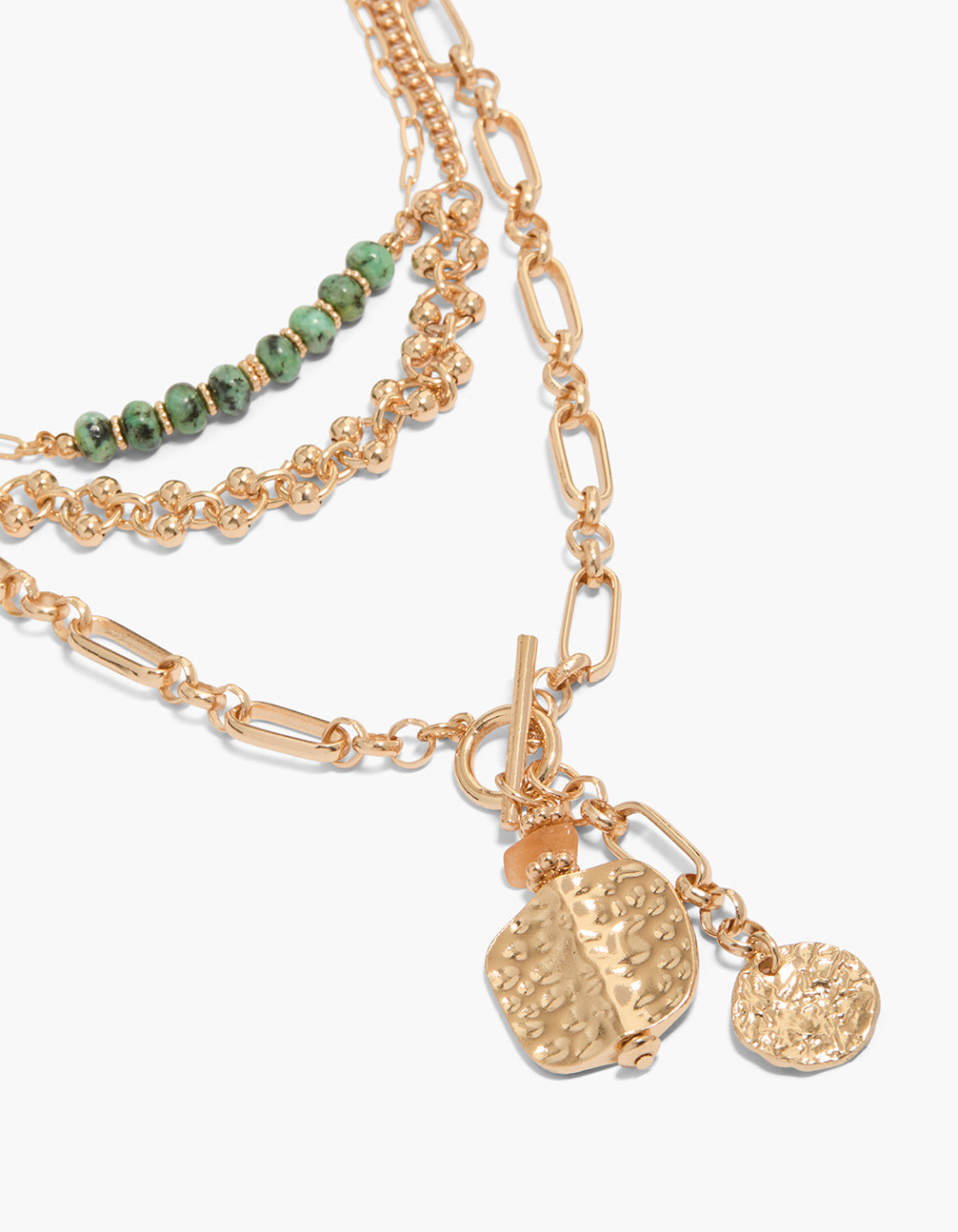 Featuring beaded, balls and disc statement necklace in gold close up view