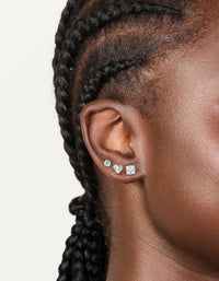 Showcasing waterproof stainless steel mixed stud earrings in a 3-pack featuring round cut cubic zirconia stones with silver and clear tones on ear view - link has visual effect only