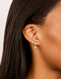 Showcasing waterproof stainless steel cubic zirconia round stud and drop earrings in a 2-pack with statement crystal design featuring silver and clear tones on ear view - link has visual effect only