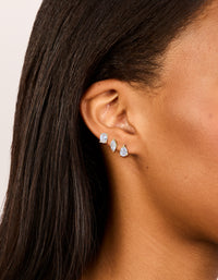 Featuring waterproof gold plated stainless steel cubic zirconia classic stud earrings in a 3-pack with round, marquise, and pear stone cuts on ear view - link has visual effect only