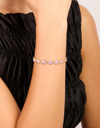 Elegant waterproof gold plated stainless steel bracelet with pink cubic zirconia oval stones and link design on wrist view - link has visual effect only