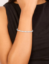 Showcasing waterproof stainless steel wrist cuff bracelet featuring marquise and round cubic zirconia in silver and clear tones on wrist view - link has visual effect only