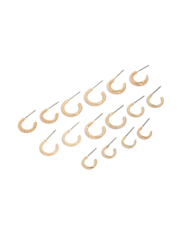 Showcasing thin round hoop earrings in gold 8-pack with varied textures front view