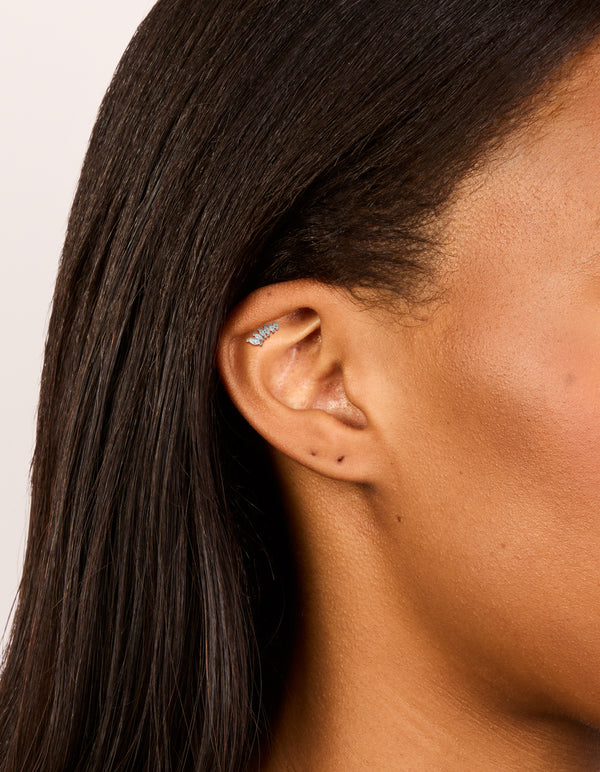 Featuring a crawler style single flat back stud earring crafted from surgical steel with cubic zirconia on ear view