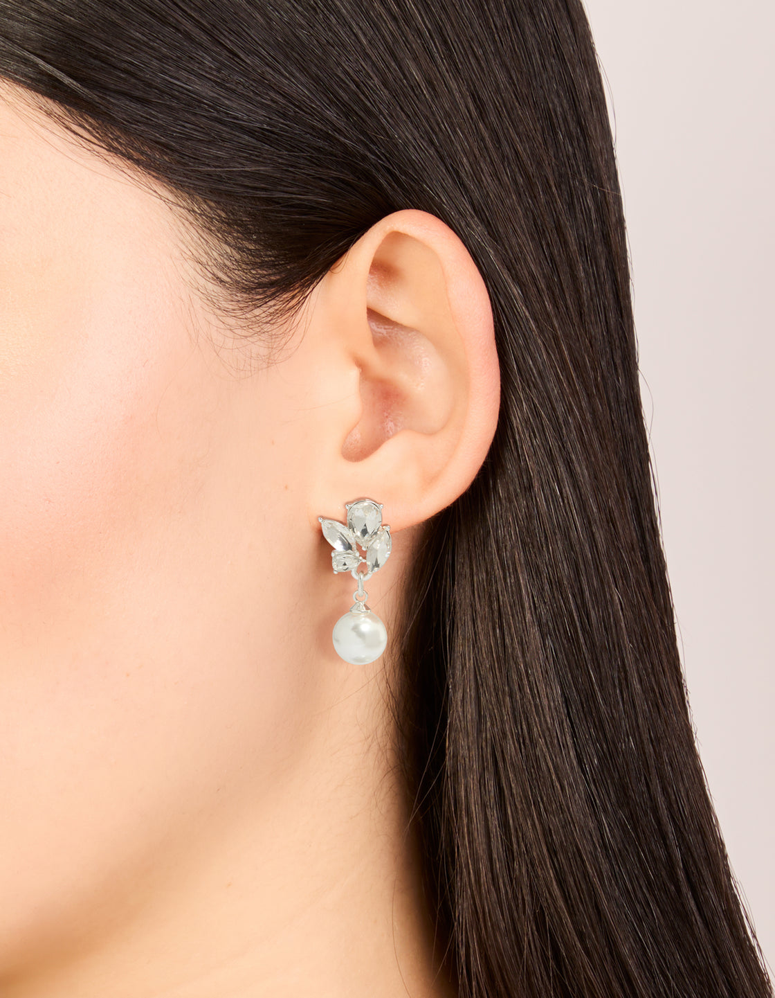 Elegant crystal marquise pearl stud drop earrings featuring white and silver design on ear view