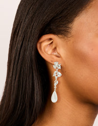 Showcasing silver pearl and crystal leaf drop earrings on ear view - link has visual effect only