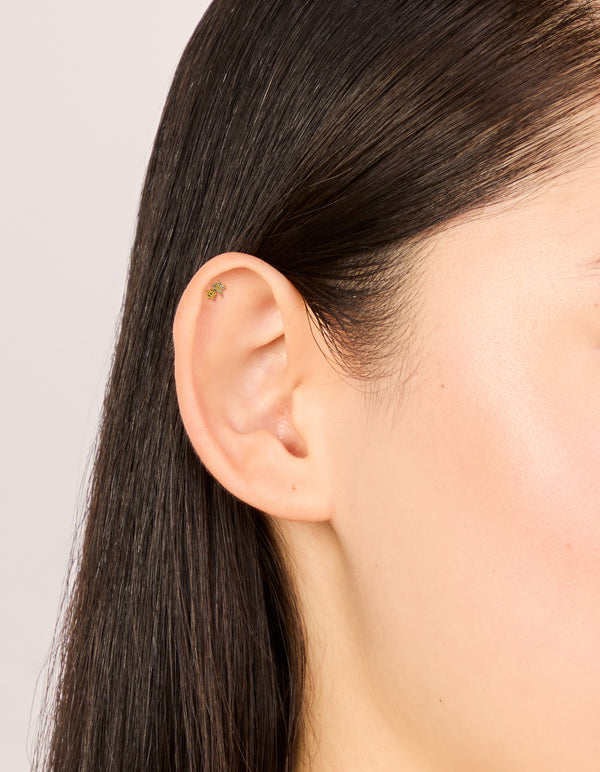 Discover dainty single gold plated titanium double flower stud with cubic zirconia and flat back closure on ear view