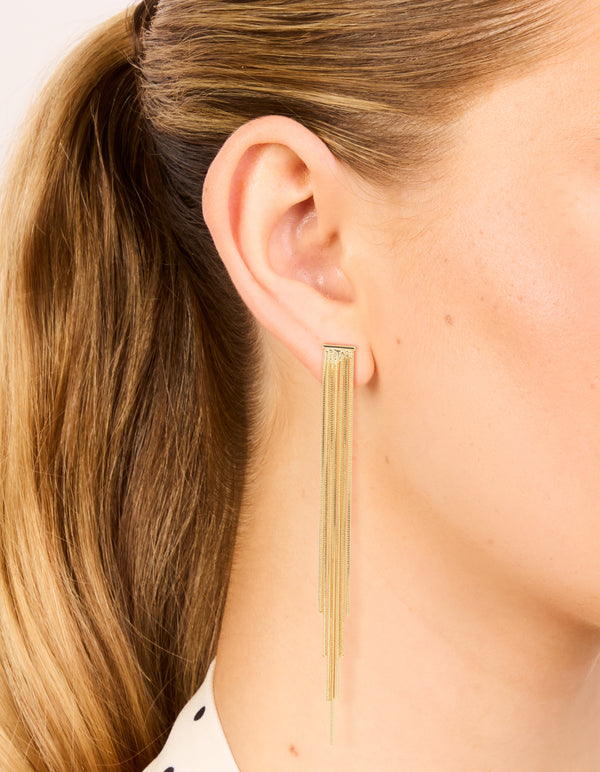 Featuring statement tassel gold plated waterfall chain drop earrings on ear view