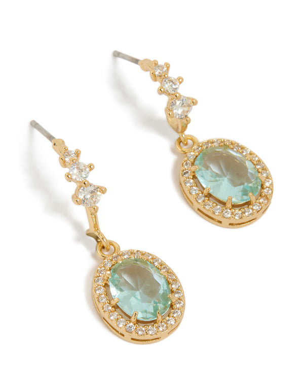 Showcasing gold plated blue cubic zirconia oval halo drop earrings with intricate stone settings front view
