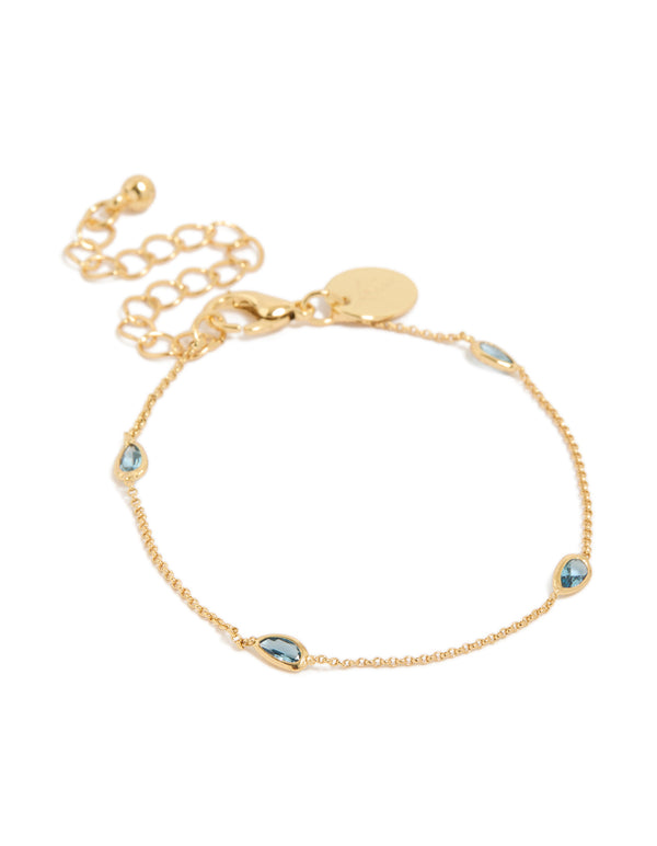 Elegant gold plated bracelet featuring blue teardrop cubic zirconia with dainty chain and adjustable closure front view