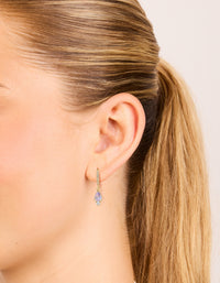 Featuring gold plated purple cubic zirconia teardrop earrings on ear view - link has visual effect only