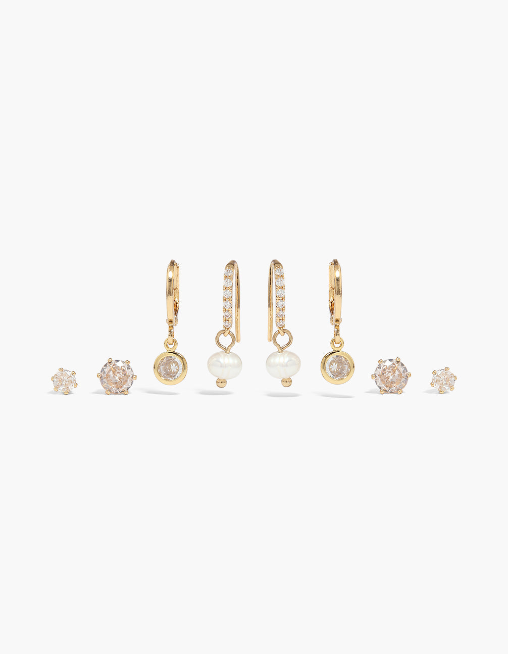 Discover this gold plated cubic zirconia and pearls earrings set featuring crystal accents with stud and huggie closures front view